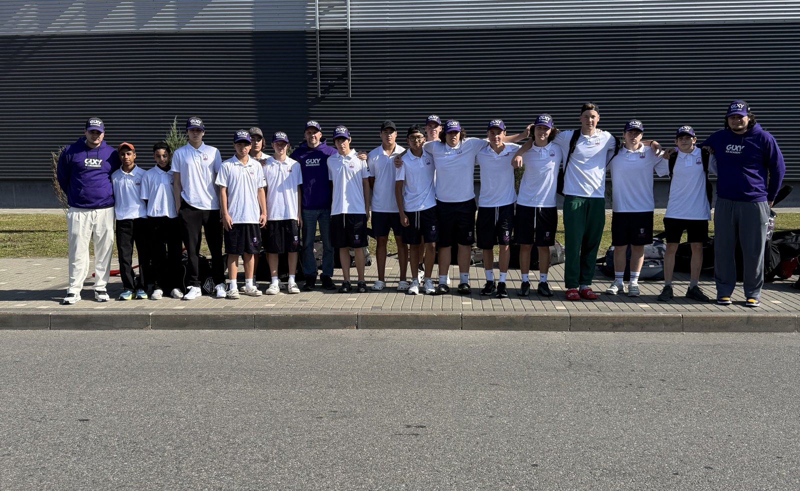 The Galaxy squad lined up by the arena wall in Minsk, white polos and purple GLXY caps