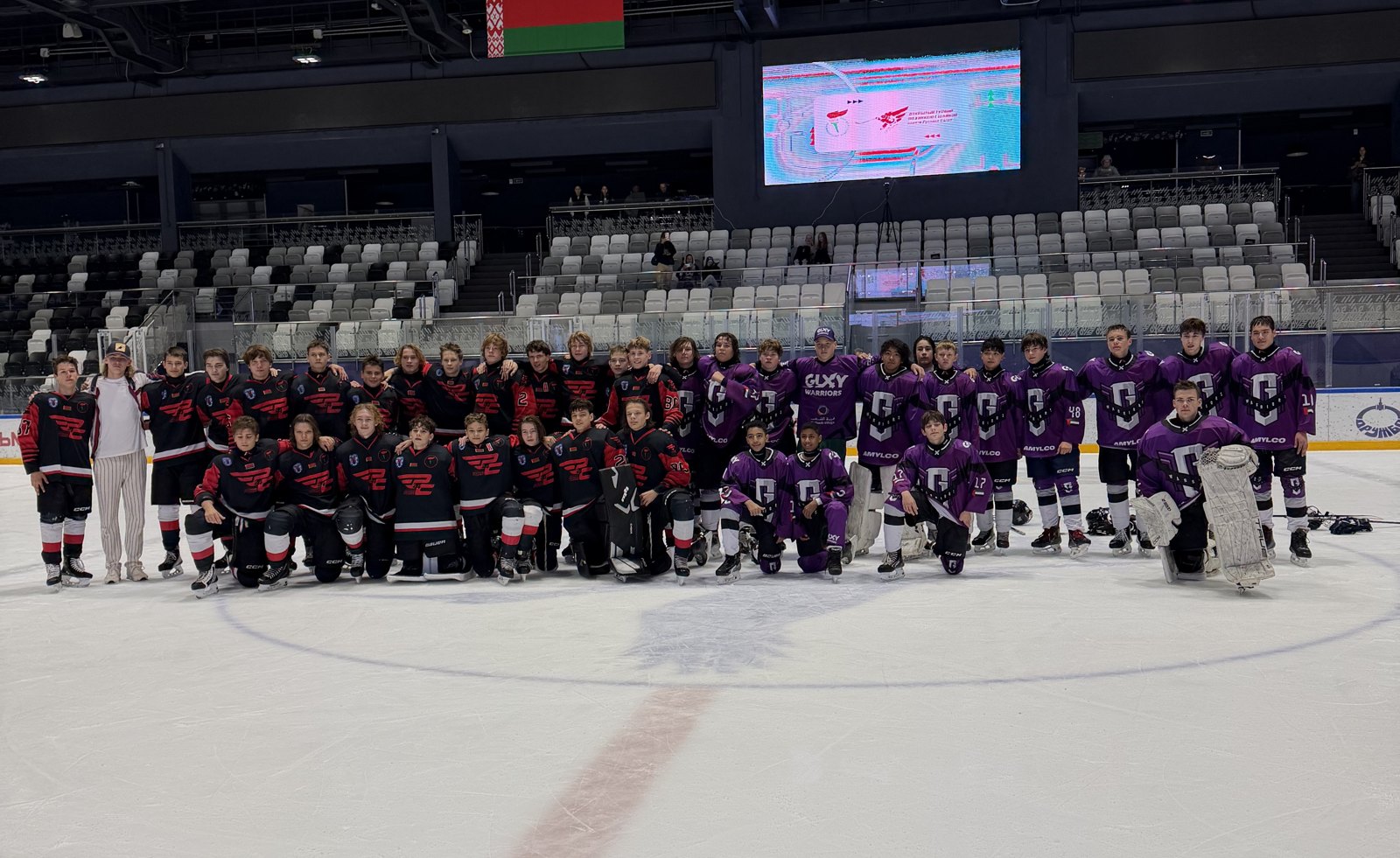 Galaxy Warriors and the other team together at centre ice in Minsk